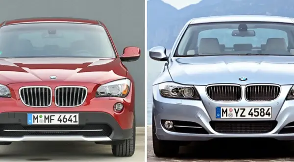 Två BMW-bilar, en röd SUV och en silverfärgad sedan, framifrån. Kanske dags för en bmw återkallelse?