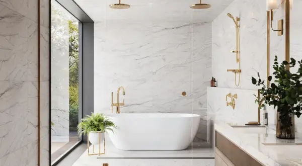 Luxurious bathroom with white marble ceramic tile on shower walls, a freestanding tub, and gold fixtures.