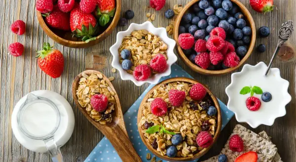 Pyszne śniadanie: granola, jogurt, mleko i świeże owoce. Idealne na dietę bogatoresztkową.