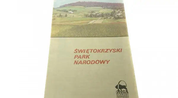 Okładka przewodnika po Świętokrzyskim Parku Narodowym z malowniczym krajobrazem i logo ochrony przyrody.