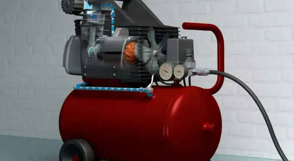 En röd kompressor med genomskuren motor som visar hur luften flödar, redo att måla med tryckluft.