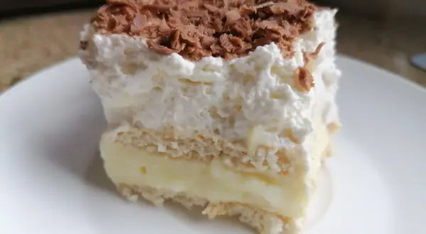 Szybkie ciasto z budyniem i bitą śmietaną, posypane wiórkami czekolady. Idealne na deser!