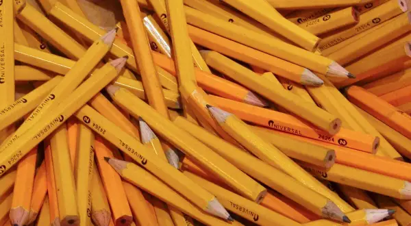 A pile of yellow pencils, a classic choice for a reason. Why are pencils yellow? It's a tradition dating back to the 1800s.