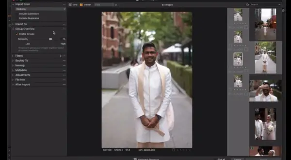 Mężczyzna w białej szacie ślubnej uśmiecha się do kamery. Capture One pozwala na import i grupowanie zdjęć.