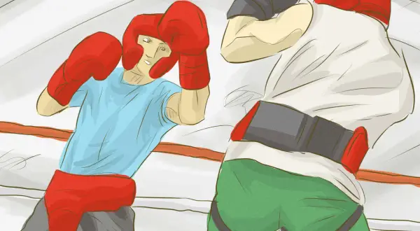 Two boxers in a ring, one in a blue shirt and red headgear, the other in a white shirt and grey cap, demonstrating how to box.