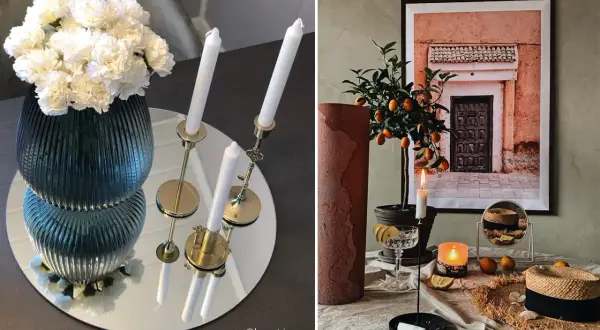 Vacker spegel vid matbordet reflekterar en vas med vita blommor och ljusstakar.