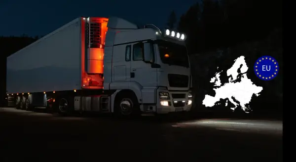 Camion blanc la nuit, éclairage LED, avec carte de l'Europe et drapeau UE. Respect de la réglementation éclairage poids lourds.