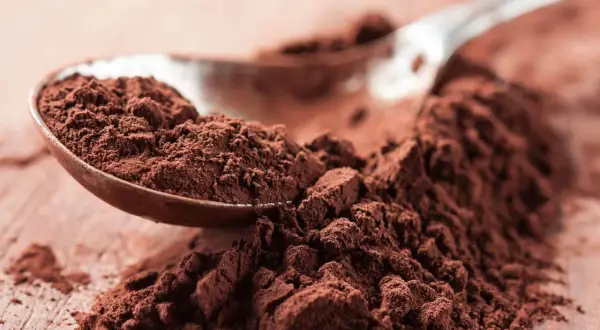 Łyżka pełna ciemnego kakao, idealna do domowych wypieków. Zastanawiasz się nad kakao kcal?
