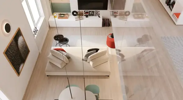 Un angolo di casa moderno e accogliente, perfetto per arredare con stile. Divano bianco, tavolino nero, quadri e giradischi creano un'atmosfera unica.