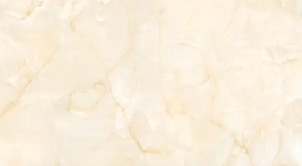 Superficie in marmo beige con venature dorate, ideale per scoprire come pulire il marmo poroso e mantenerlo splendente.