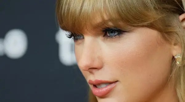 Taylor Swift's profile, with striking blue eyes and blonde bangs, hints at her latest Spotify release.