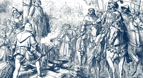 Jan Hus Tag: Ein Mann wird am Scheiterhaufen verbrannt, während Reiter und eine Menge zusehen.