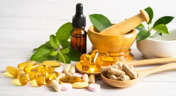 Naturheilkunde mit Pillen und Kapseln. Vorsicht bei zu hoher Dosierung von Vitamin E, Nebenwirkungen sind möglich.