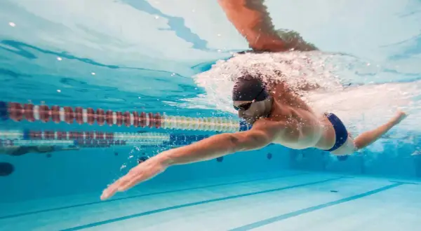 Uomo nuota in piscina, un ottimo modo per il nuoto per dimagrire e tonificare il corpo.