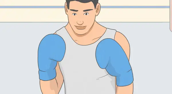 A boxer in blue gloves stands ready, his stance showing he's prepared to spare no effort in the ring.
