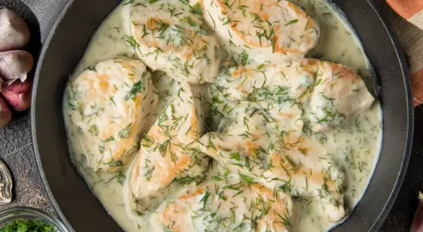Pyszny kurczak w sosie śmietanowym z koperkiem, podany w żeliwnej patelni. Aromatyczny i kremowy.