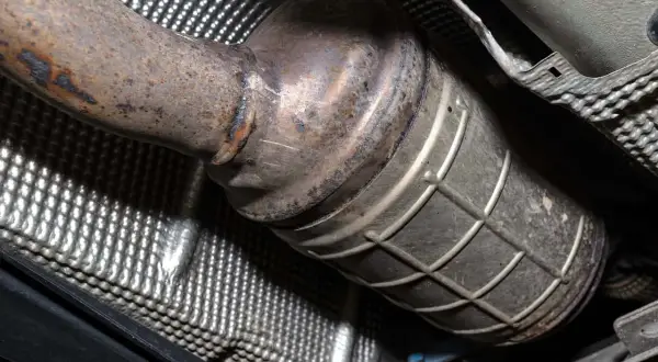 Zardzewiały element układu wydechowego, prawdopodobnie filtr DPF. Sprawdź czyszczenie DPF cena, by przywrócić sprawność.