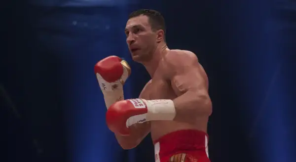 Wladimir Klitschko in a boxing stance, his powerful reach evident as he prepares to strike.