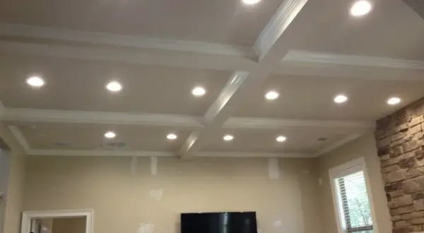 A coffered ceiling with recessed lighting, questioning if recessed lighting is out of style.