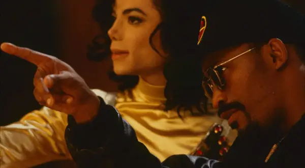 Teddy Riley points as Michael Jackson looks on, a moment captured during their creative collaboration.