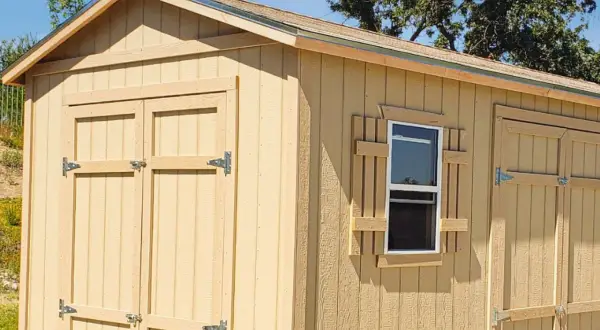 A newly built shed with double doors and a window. This shed is ready to build your dreams in.