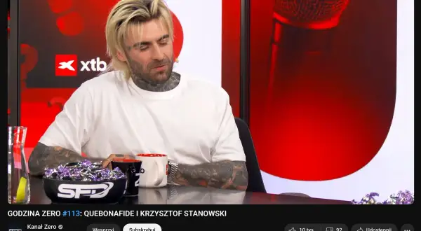 Quebonafide w programie "Godzina Zero" z Krzysztofem Stanowskim. Widać jego charakterystyczny styl i tatuaże. Rozmowa o jego karierze i wzroście popularności.