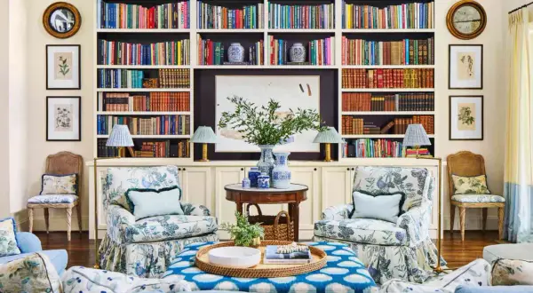 Ideas on how to decorate a bookshelf: a cozy living room with built-in shelves filled with books, art, and decorative vases.