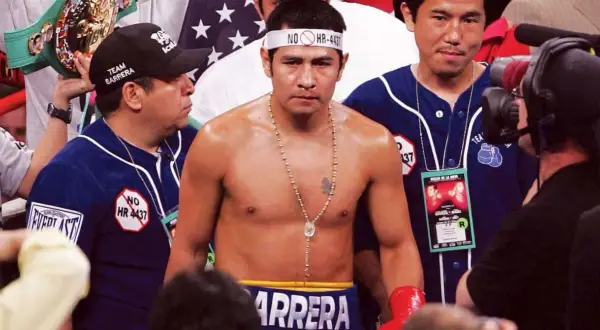 Marco Antonio Boxer, the champion, stands ready, a championship belt held high by his team.