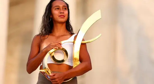 Taylor Fernandez proudly holds a golden trophy, a symbol of her hard-earned victory.