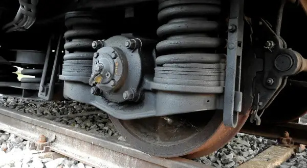 Zbliżenie na mechanizm koła kolejowego, sprężyny i elementy układu hamulcowego. To kluczowe dla skrócenia drogi hamowania pociągu.