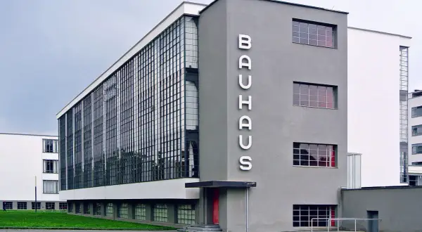 Iconic Bauhaus architecture examples: the Dessau building with its glass curtain wall and prominent "BAUHAUS" lettering.