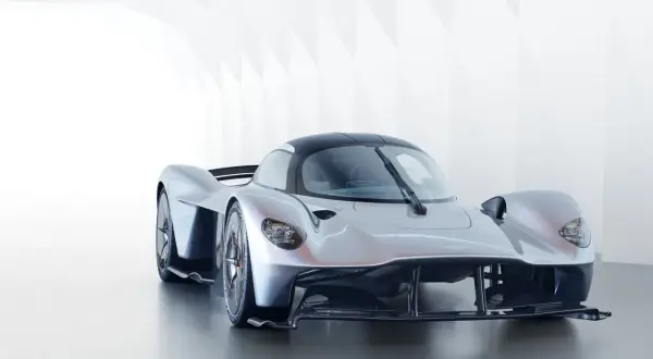 Srebrny Aston Martin Valkyrie, supersamochód o futurystycznym designie, prezentuje swoje aerodynamiczne linie w minimalistycznym wnętrzu.