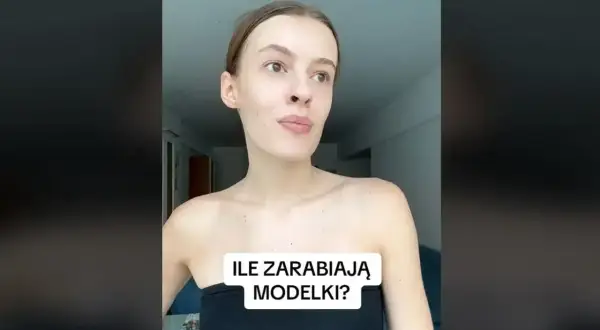 Młoda kobieta w czarnym topie zastanawia się, ile zarabia modelka w Polsce.