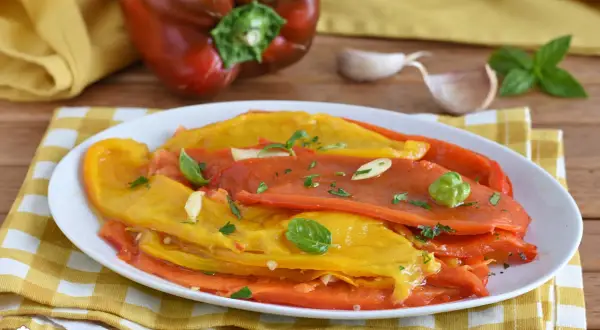 Deliziosa insalata di peperoni arrostiti, condita con aglio, basilico e prezzemolo. Un contorno colorato e saporito.