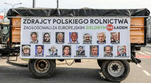 Plakat na przyczepie z portretami europosłów i napisem "Zdrajcy polskiego rolnictwa".
