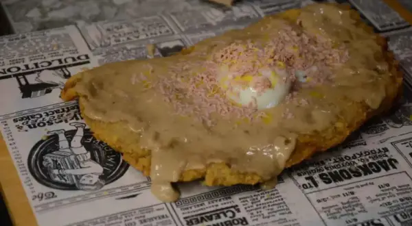 Plato de comida con huevo y salsa, ideal para comer barato en Zaragoza cerca del Pilar.