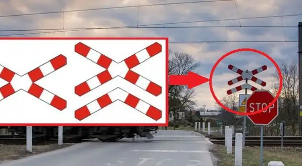 Ostrzeżenie o przejeździe kolejowym z krzyżami św. Andrzeja i znakiem STOP.