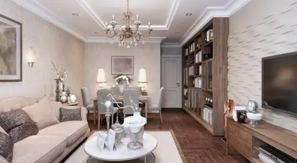 Elegancki salon z jadalnią, gdzie króluje styl w domu. Jasna sofa, kryształowy żyrandol i regał z książkami tworzą przytulną atmosferę.