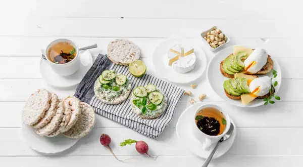 Colazione sana per la dieta 3 giorni: toast con avocado e uovo, gallette con formaggio e cetriolo, tè e formaggio brie.