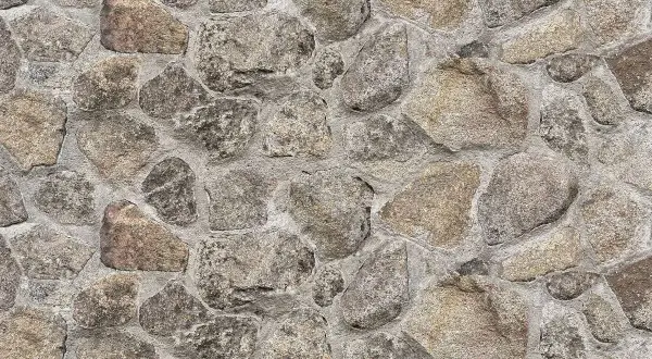 Kamień naturalny w murze, szary i brązowy. Czym czyścić kamień naturalny? Delikatnie, by nie uszkodzić jego piękna.