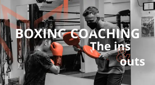 A coach demonstrates boxing techniques to a young boxer, highlighting the ins and outs of coaching boxing.