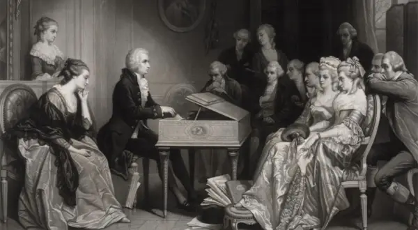 En scen med musiker och åhörare, där en man vid ett klaver kan vara Mozart, medan en annan figur, möjligen Salieri, observerar.