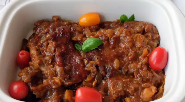 Karkówka w sosie własnym z pomidorami i bazylią, duszona w Coca-Coli. Pyszne danie gotowe do podania.