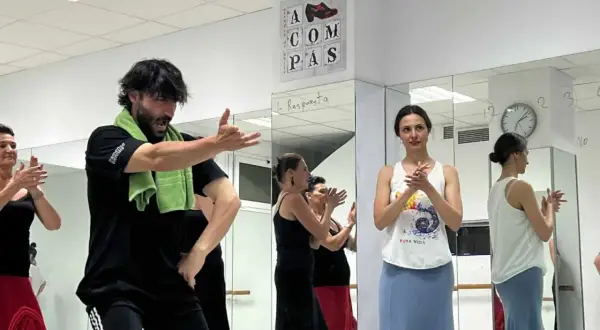 Clase de sevillanas rápidas con un instructor masculino y varias mujeres practicando.
