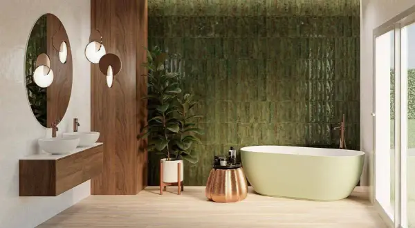 Salle de bain moderne avec mur texturé vert émeraude, parfait pour une inspiration salle de bain zellige. Bain autoportant, double vasque et bois chaleureux.