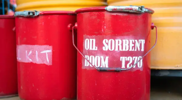 Czerwone wiadra z napisem "OIL SORBENT BOOM T270" i "KIT" gotowe do użycia. Dysperbent czeka na akcję.