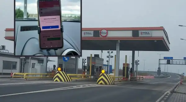 Telefon z aplikacją do opłat za autostradę A2 zamontowany w samochodzie przed bramkami e-TOLL.