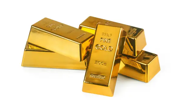 Lingotes de oro brillante apilados. El oro se utiliza para inversión, joyería y como reserva de valor.