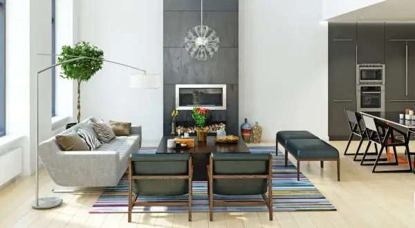 Nowoczesny salon z kominkiem i kuchnią. Styl wykończenia wnętrz to połączenie minimalizmu i elegancji.