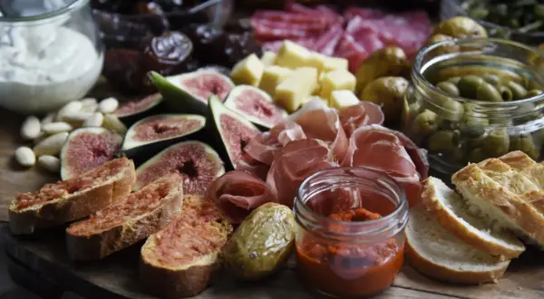 Eine köstliche fingerfood tapas platte mit Feigen, Schinken, Oliven, Brot und Dips.